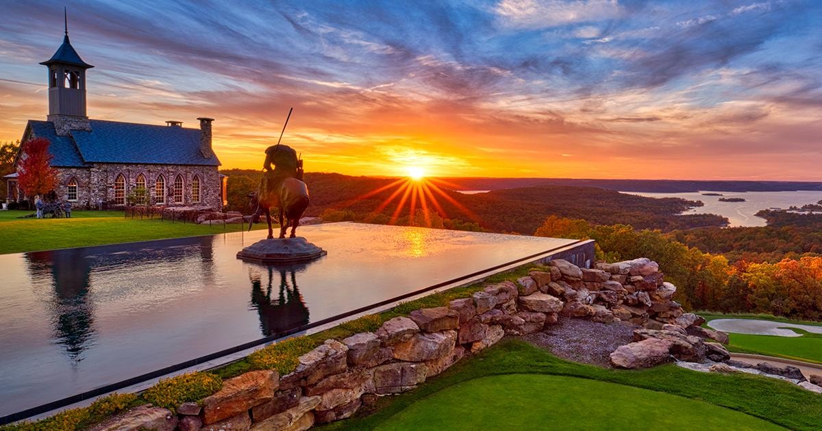 Sunset over Table Rock Lake from Top of the Rock with stone chapel and infinity pool